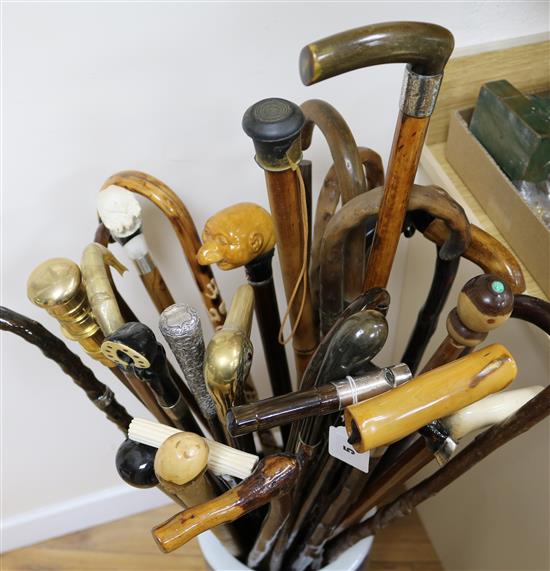 A collection of walking sticks, approx. 30, including a silver top whistle stick